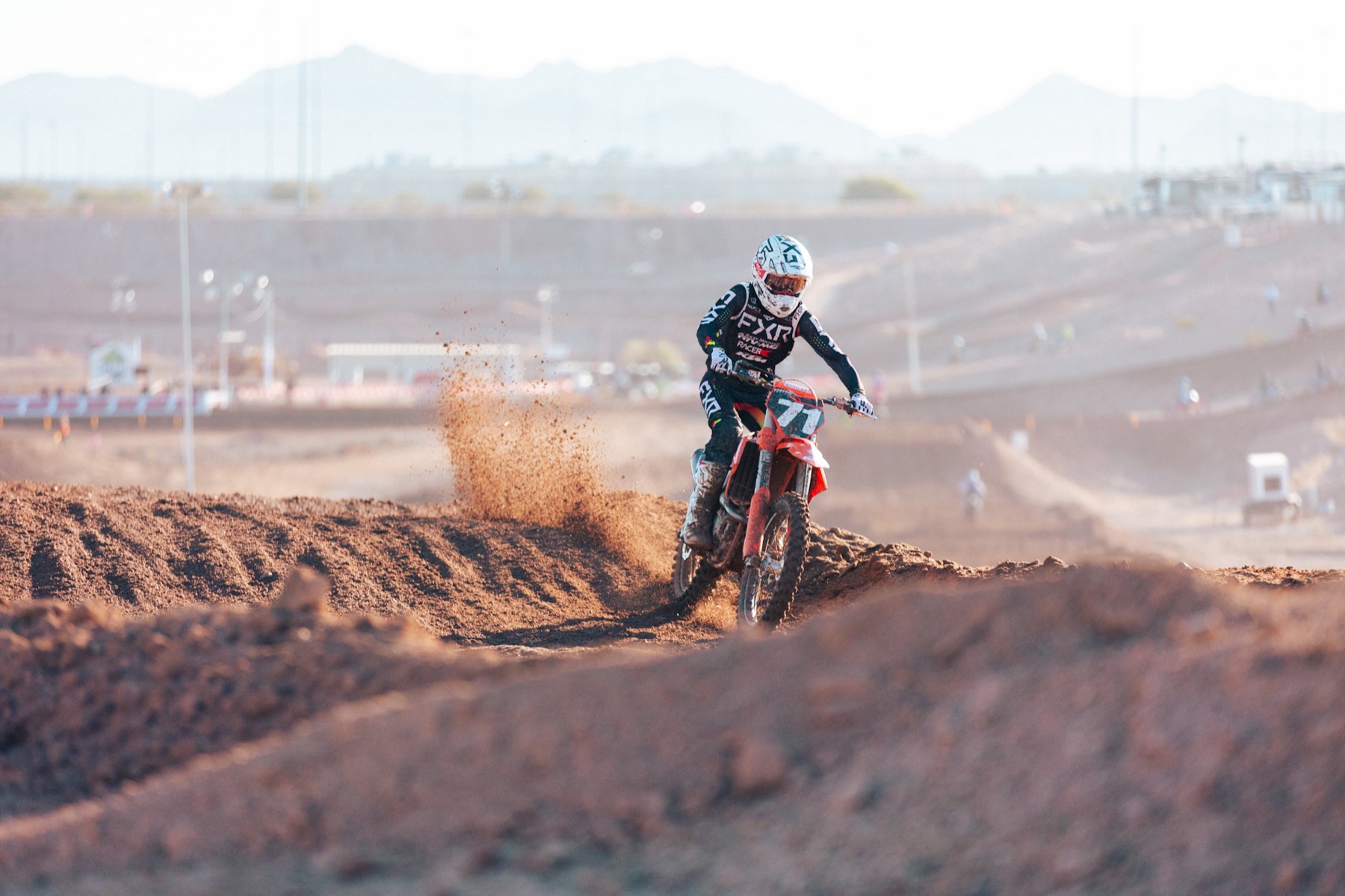 AZ Open rider throwing roost against the mountains