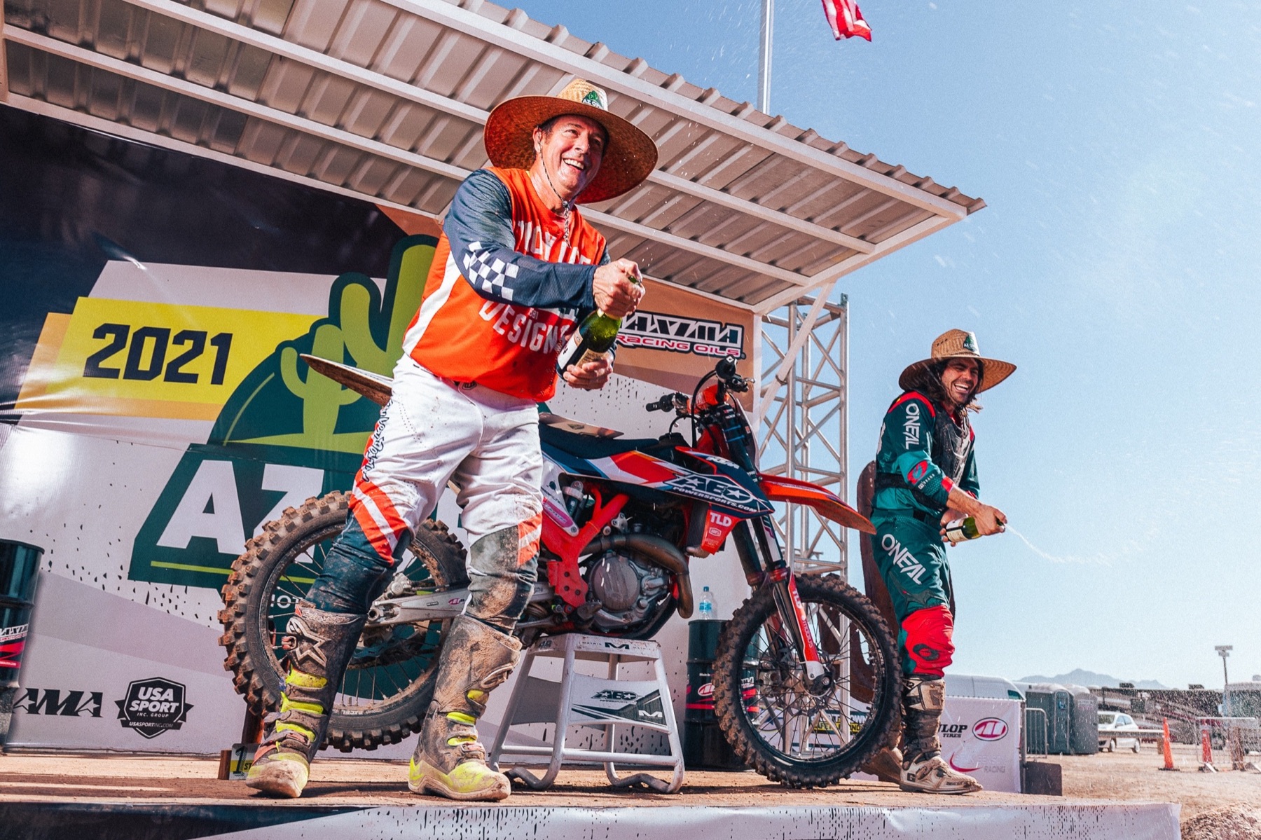 AZ Open champions spraying champagne on the podium