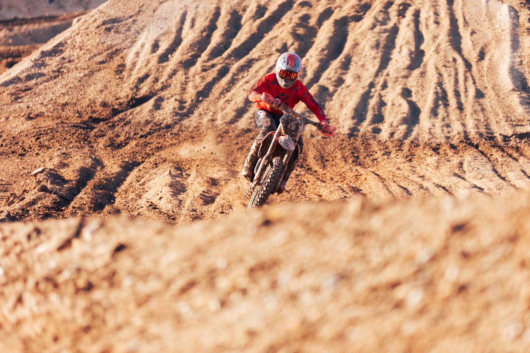 AZ Open racer charging across a deeply rutted track