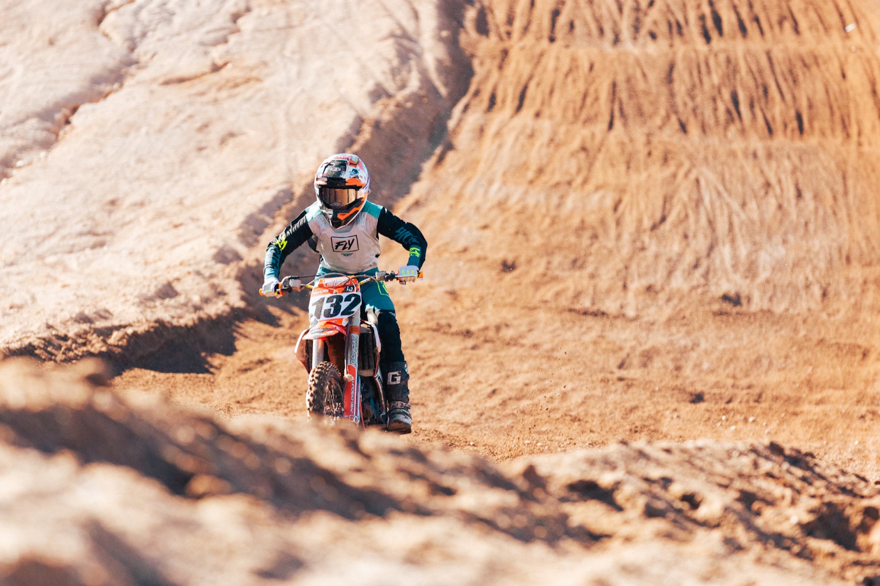 Young AZ Open rider crossing the desert track